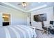 Main bedroom with built-in workspace and large TV at 17721 Bright Wheat Dr, Lithia, FL 33547