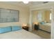 Relaxing bedroom with mirrored closet and ocean view artwork at 214 Elmwood Cir # 214, Seminole, FL 33777