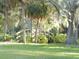 Wooden footbridge in a park-like setting with mature trees and landscaping at 214 Elmwood Cir # 214, Seminole, FL 33777