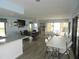 Bright community room with tables, chairs, and a TV at 214 Elmwood Cir # 214, Seminole, FL 33777