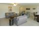 Spacious living room with gray sofas, light flooring, and built-ins at 214 Elmwood Cir # 214, Seminole, FL 33777