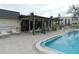 Relaxing pool area with covered seating and lounge chairs at 214 Elmwood Cir # 214, Seminole, FL 33777