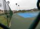 Community tennis court with surrounding fence at 214 Elmwood Cir # 214, Seminole, FL 33777
