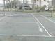 Community tennis court with net and lines at 214 Elmwood Cir # 214, Seminole, FL 33777