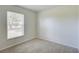 Well-lit bedroom featuring a window with blinds and neutral walls at 2369 N Biscayne Dr, North Port, FL 34291