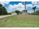 House exterior view, showcasing a driveway and landscaping at 2369 N Biscayne Dr, North Port, FL 34291