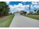 Front view of the house with a long driveway at 2369 N Biscayne Dr, North Port, FL 34291