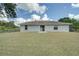 Backyard view of house with spacious grassy area at 2369 N Biscayne Dr, North Port, FL 34291