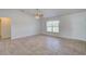 Spacious living room with tile floors and ceiling fan at 2369 N Biscayne Dr, North Port, FL 34291