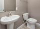Small bathroom with pedestal sink and toilet at 2436 Sand Gables Trl, Bradenton, FL 34208
