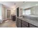 Double vanity bathroom with granite countertop and walk-in shower at 2436 Sand Gables Trl, Bradenton, FL 34208