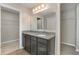 Bathroom with granite countertop, dark brown vanity, and walk-in shower at 2436 Sand Gables Trl, Bradenton, FL 34208