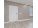 Front entry with white door, gray walls, and wood-look flooring at 2436 Sand Gables Trl, Bradenton, FL 34208