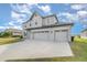 Two-story house with gray siding, three-car garage, and landscaping at 2436 Sand Gables Trl, Bradenton, FL 34208