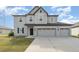 Two-story house with gray siding, three-car garage, and landscaping at 2436 Sand Gables Trl, Bradenton, FL 34208