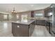 Spacious kitchen with granite island and dark wood cabinetry at 2436 Sand Gables Trl, Bradenton, FL 34208