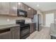 Modern kitchen with black appliances and granite countertops at 2436 Sand Gables Trl, Bradenton, FL 34208