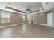 Main bedroom with ceiling fan, wood-look floors, and access to bathroom at 2436 Sand Gables Trl, Bradenton, FL 34208