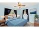 Light blue bedroom with a queen bed and ceiling fan at 2699 56Th N Ln, St Petersburg, FL 33710