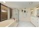 Bathroom with a large tub, shower, and white cabinetry at 2795 Kipps Colony S Dr # 104, St Petersburg, FL 33707