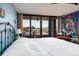 Main bedroom with a large bed, water views, and ample closet space at 2795 Kipps Colony S Dr # 104, St Petersburg, FL 33707