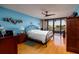 Spacious bedroom with water views, hardwood floors, and a ceiling fan at 2795 Kipps Colony S Dr # 104, St Petersburg, FL 33707