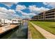 Community boat dock with walkway and lush green grass at 2795 Kipps Colony S Dr # 104, St Petersburg, FL 33707