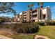 Building exterior with lush landscaping and palm trees at 2795 Kipps Colony S Dr # 104, St Petersburg, FL 33707
