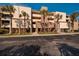 Exterior view of condo building with palm trees at 2795 Kipps Colony S Dr # 104, St Petersburg, FL 33707