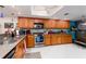 Condo kitchen with wood cabinets, stainless appliances at 2795 Kipps Colony S Dr # 104, St Petersburg, FL 33707