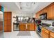 Condo kitchen with wood cabinets and stainless steel appliances at 2795 Kipps Colony S Dr # 104, St Petersburg, FL 33707