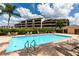 Community pool with lounge chairs and patio area at 2795 Kipps Colony S Dr # 104, St Petersburg, FL 33707