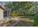 Landscaped backyard with mature trees and a spacious lawn at 3028 Summervale Dr, Holiday, FL 34691