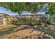Partial view of backyard with screened pool and lush landscaping at 3028 Summervale Dr, Holiday, FL 34691
