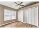 Bedroom with ceiling fan, window blinds and large closets at 3028 Summervale Dr, Holiday, FL 34691