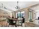 Dining area with a round table, chandelier, and access to the backyard at 3028 Summervale Dr, Holiday, FL 34691