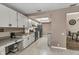 Kitchen with white cabinets, stainless steel appliances, and tile flooring at 3028 Summervale Dr, Holiday, FL 34691