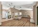 Open living room featuring a fireplace, L-shaped sofa, and wood-look floors at 3028 Summervale Dr, Holiday, FL 34691