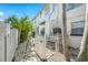 Landscaped backyard with a stone pathway and white fence at 3031 W Asbury Pl, Tampa, FL 33611