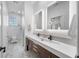 Modern bathroom with double vanity, marble tile, and updated fixtures at 3031 W Asbury Pl, Tampa, FL 33611