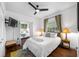 Bedroom with queen-size bed, and an adjacent bedroom at 3031 W Asbury Pl, Tampa, FL 33611