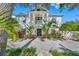 Two-story house with white exterior, landscaping, and a circular driveway at 3031 W Asbury Pl, Tampa, FL 33611
