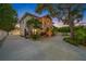 Two-story house with a circular driveway and lush landscaping at night at 3031 W Asbury Pl, Tampa, FL 33611