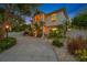 Two-story house with a circular driveway and lush landscaping at night at 3031 W Asbury Pl, Tampa, FL 33611