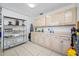 Galley kitchen with light wood cabinets and ample counter space at 3031 W Asbury Pl, Tampa, FL 33611