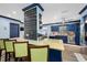 Kitchen with breakfast bar, blue cabinetry, and chalkboard feature wall at 3031 W Asbury Pl, Tampa, FL 33611
