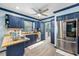 Modern kitchen with blue cabinets, granite countertops, and stainless steel appliances at 3031 W Asbury Pl, Tampa, FL 33611