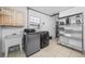 Bright laundry room with a sink, washer, dryer, and storage at 3031 W Asbury Pl, Tampa, FL 33611