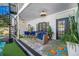 Ground level patio with comfortable seating and a vibrant rug at 3031 W Asbury Pl, Tampa, FL 33611