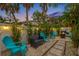 Evening view of patio with fire pit and string lights at 3031 W Asbury Pl, Tampa, FL 33611